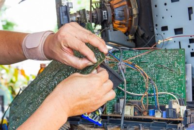 Technician repairing old television or tv vintage in repair shop