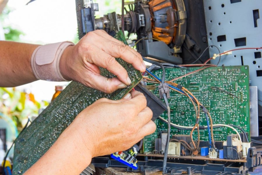 Technician repairing old television or tv vintage in repair shop